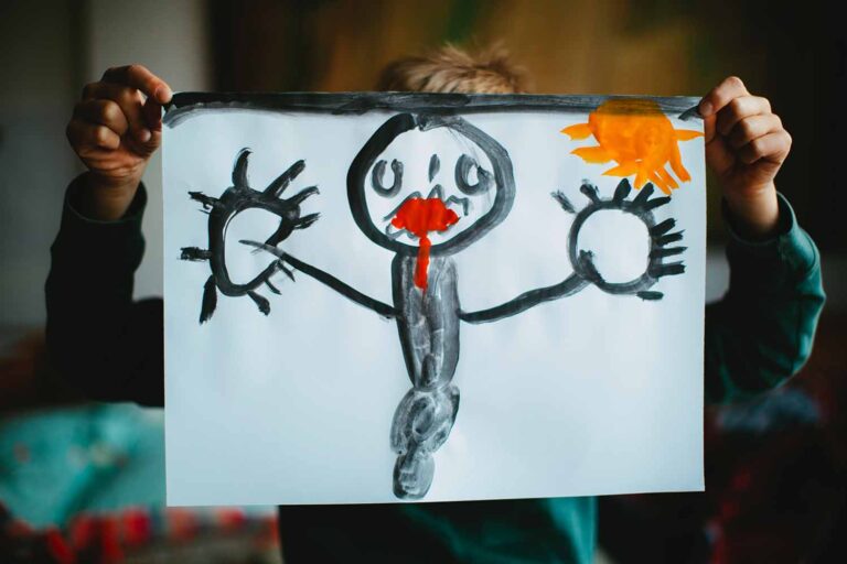 A child's drawing of a black monster with a red mouth